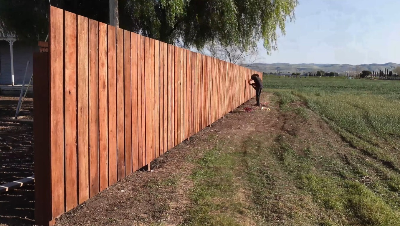 Reliable fence installation crew working on long residential wood fence in Hacienda Heights, CA
